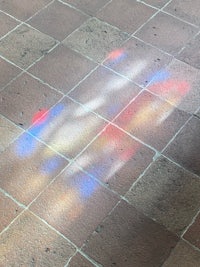 an image of a stained glass window on a tiled floor